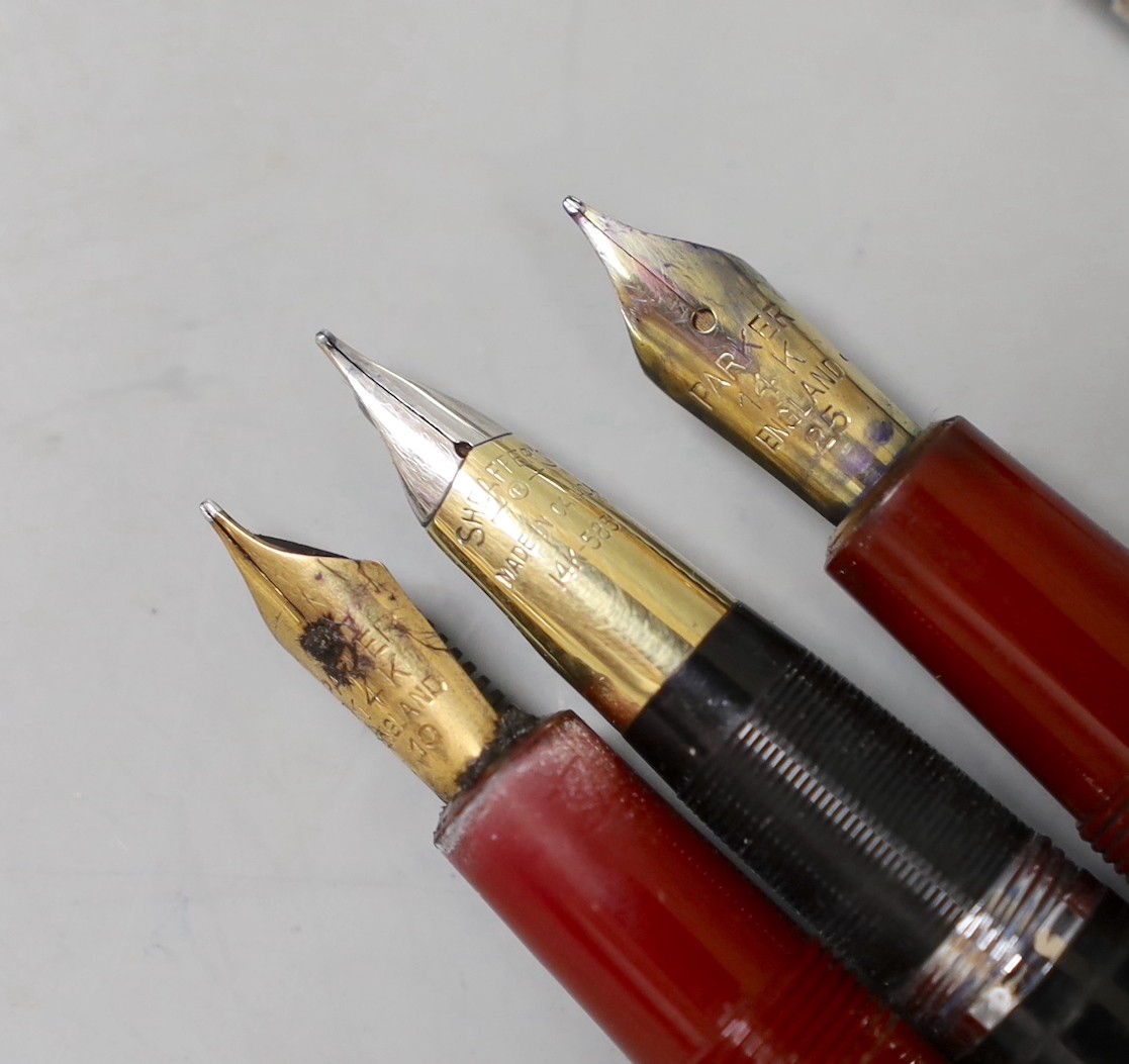 Two Parker fountain pens including Junior and three other pens or pencils including two silver cased.